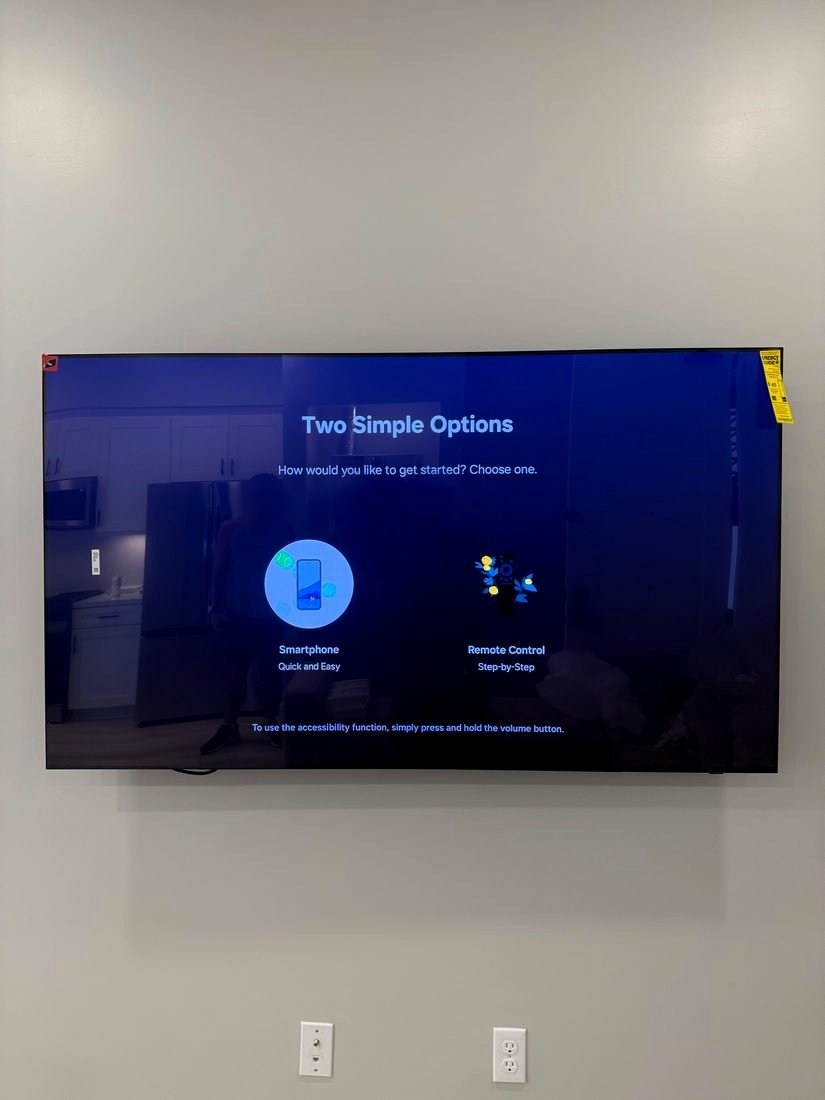 A TV on a gray wall showing its setup screen